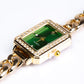 Uhr aus goldplattierter Legierung mit Smaragd