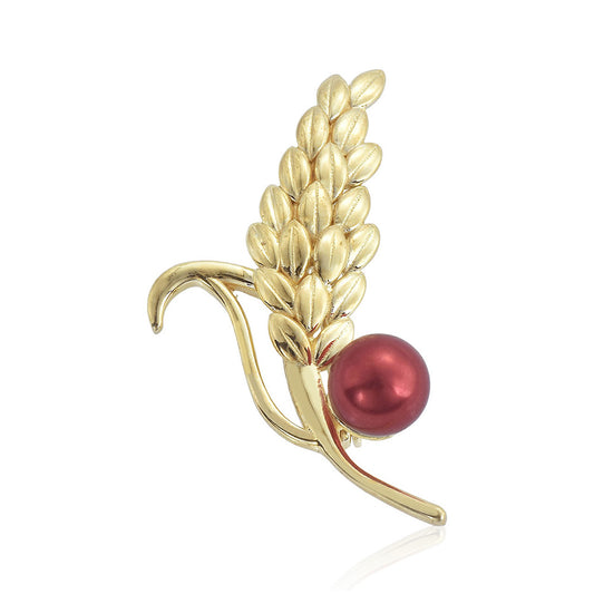 Goldplattierte Silberbrosche mit roter Süßwasserperle