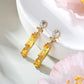 Ohrringe aus goldplattierter Legierung mit gelbem Emporia®-Kristall und weißem Emporia® Kristall