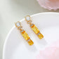 Ohrringe aus goldplattierter Legierung mit gelbem Emporia®-Kristall und weißem Emporia® Kristall